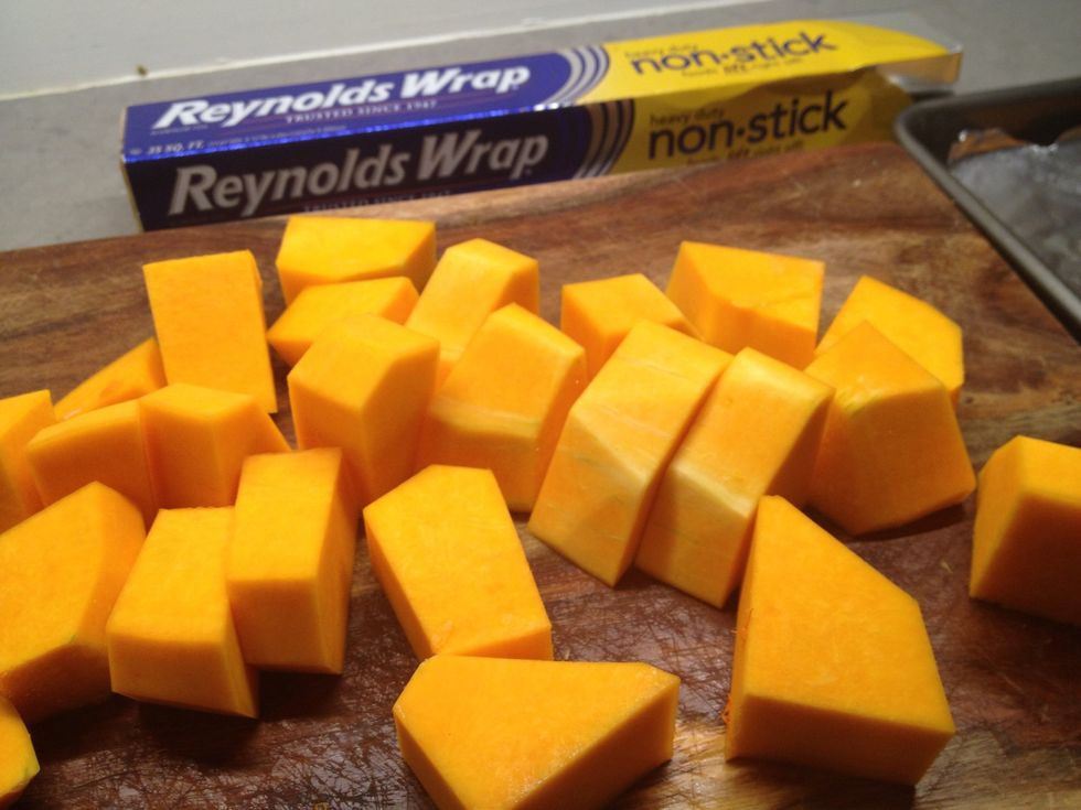 Squash is cut up! I use that fabulous non-stick foil to cover the baking sheet. (Parchment paper works too) and it's time to lightly coat the pieces with coconut or olive oil.