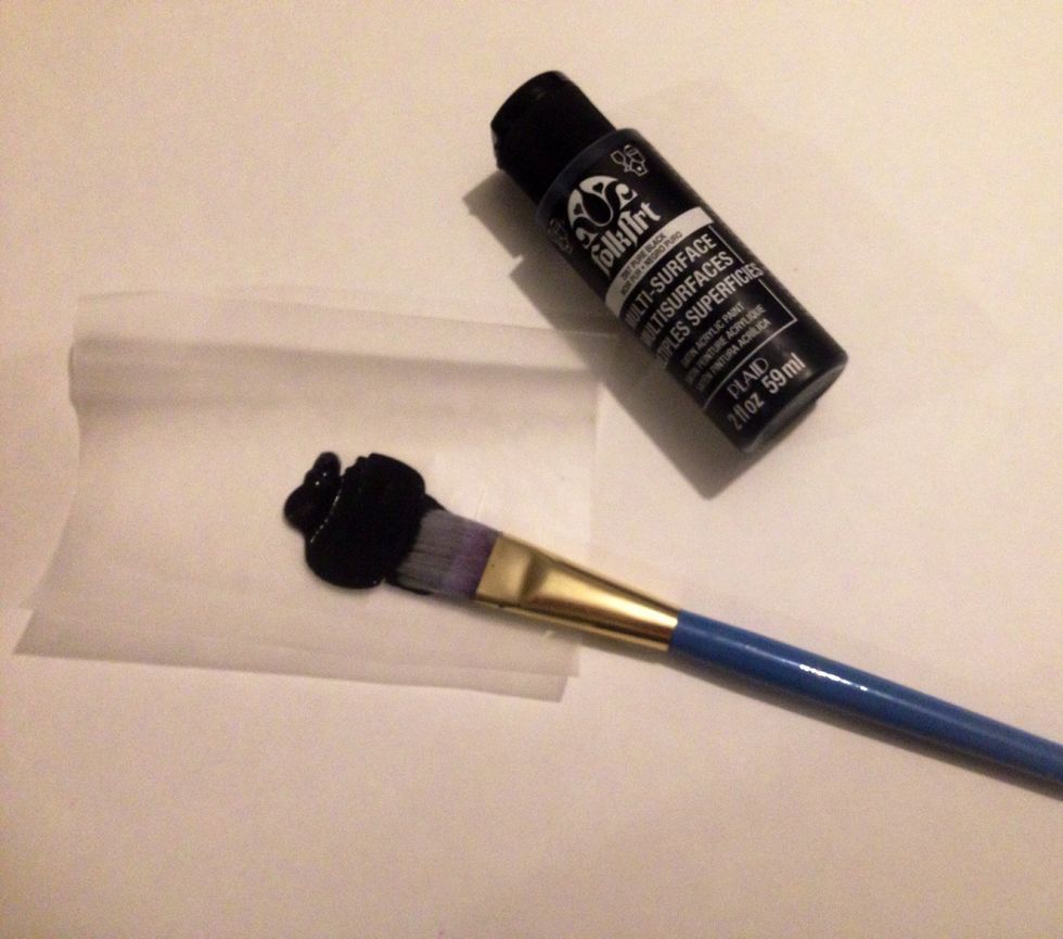 Squeeze a quarter size amount of black paint onto the wax paper. Brush the paint out onto the surface.