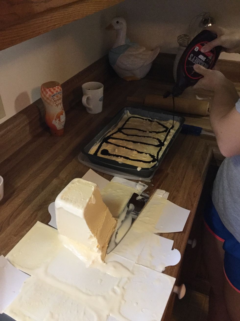 Squeeze chocolate and caramel syrup over ice cream.