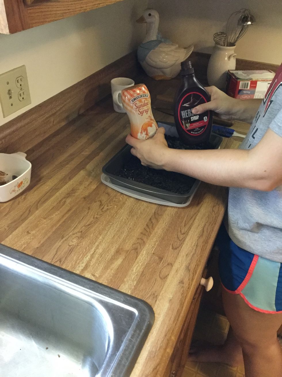 Squeeze chocolate and caramel syrup over mixture.