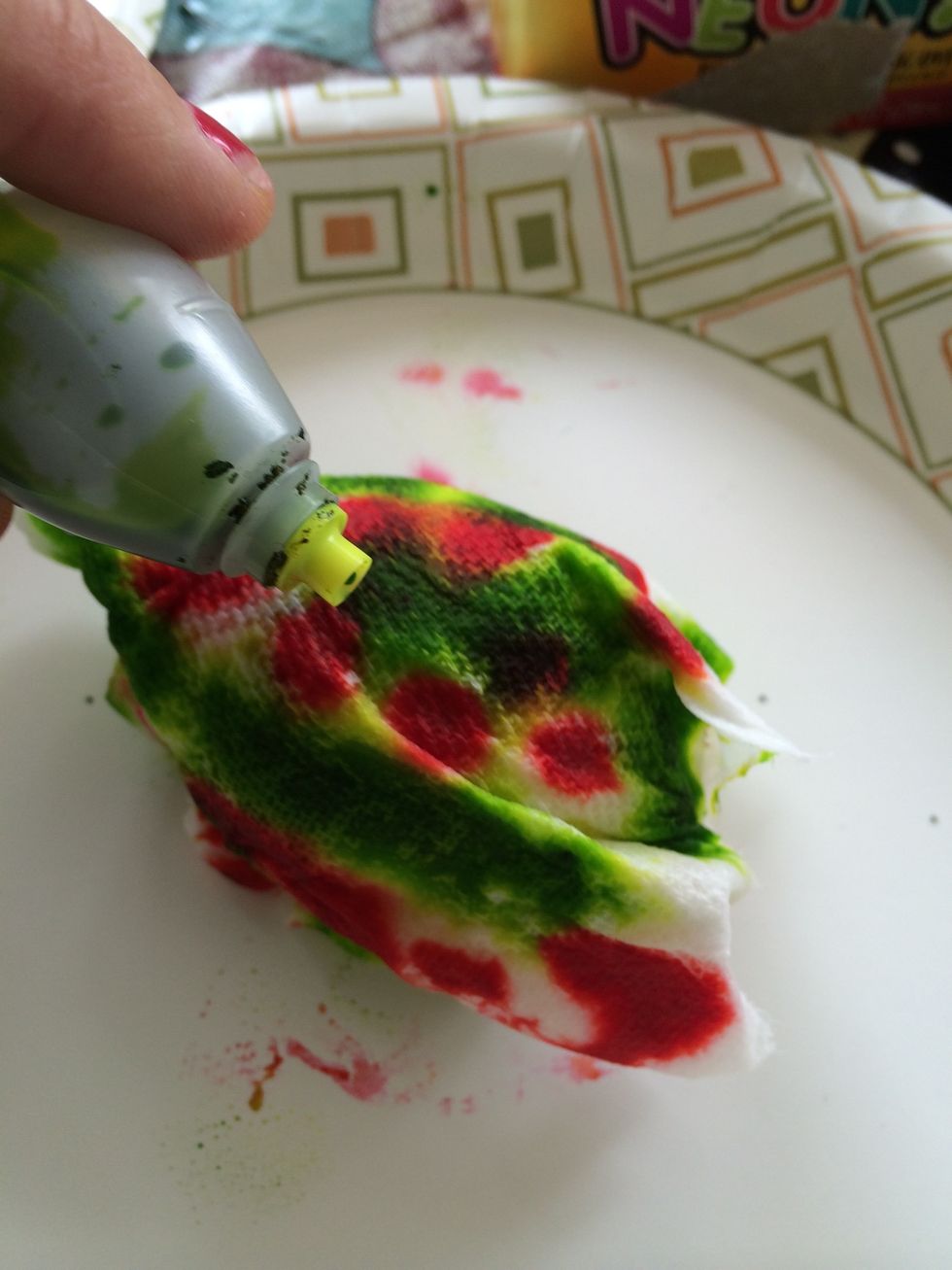 Squeeze food color into spots on the paper towel let it seep onto the egg.