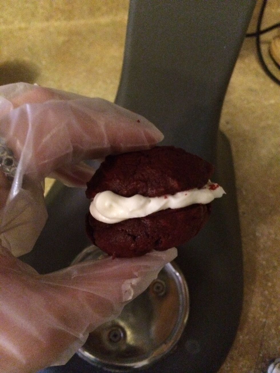 Squeeze frosting onto flat side of the middle of one half of cookie and top with a second cookie