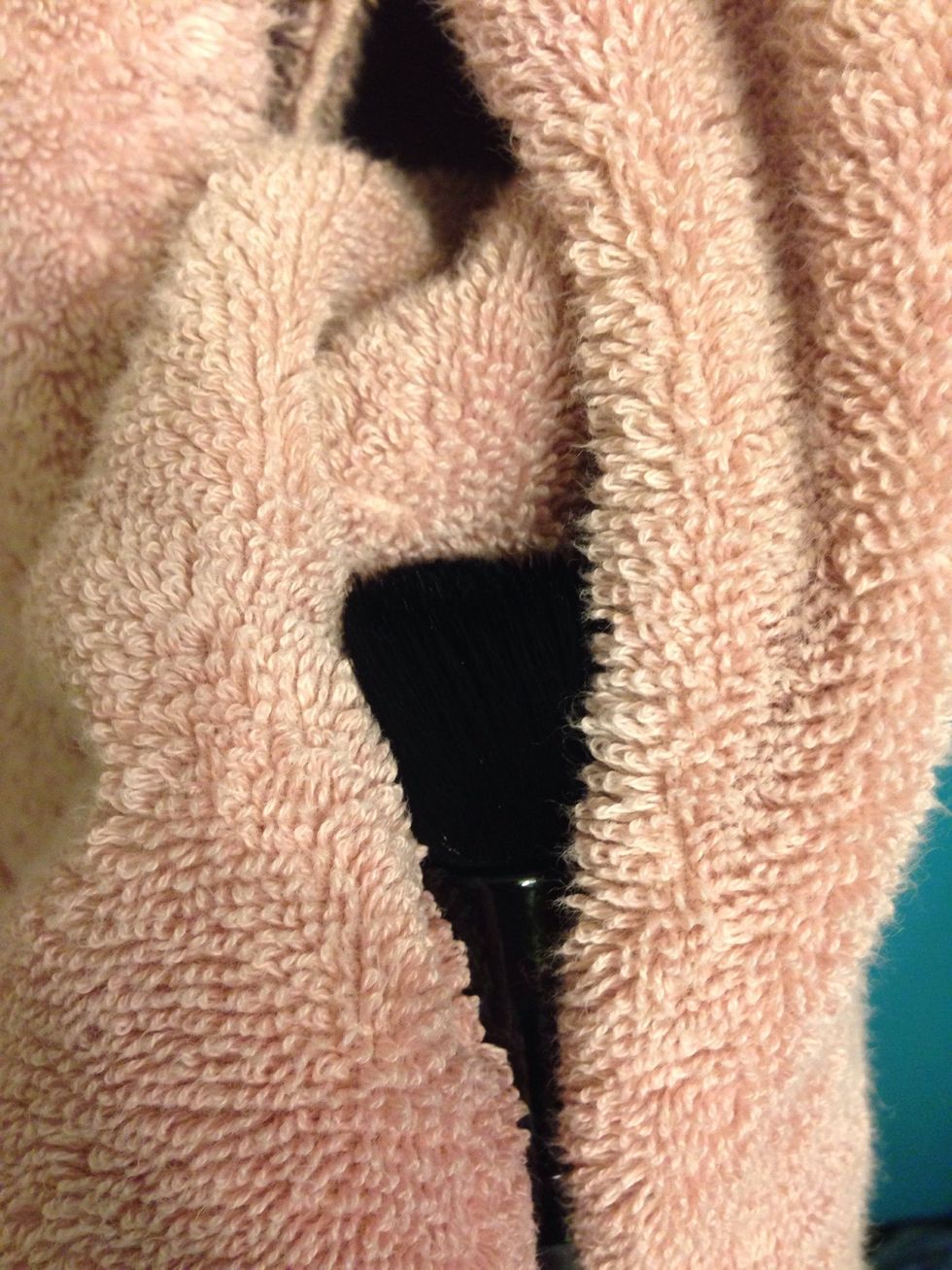 Squeeze gently in a dry towel to soak up dripping water. Use the same circular motion you used to wash the brush to dry the bristles.