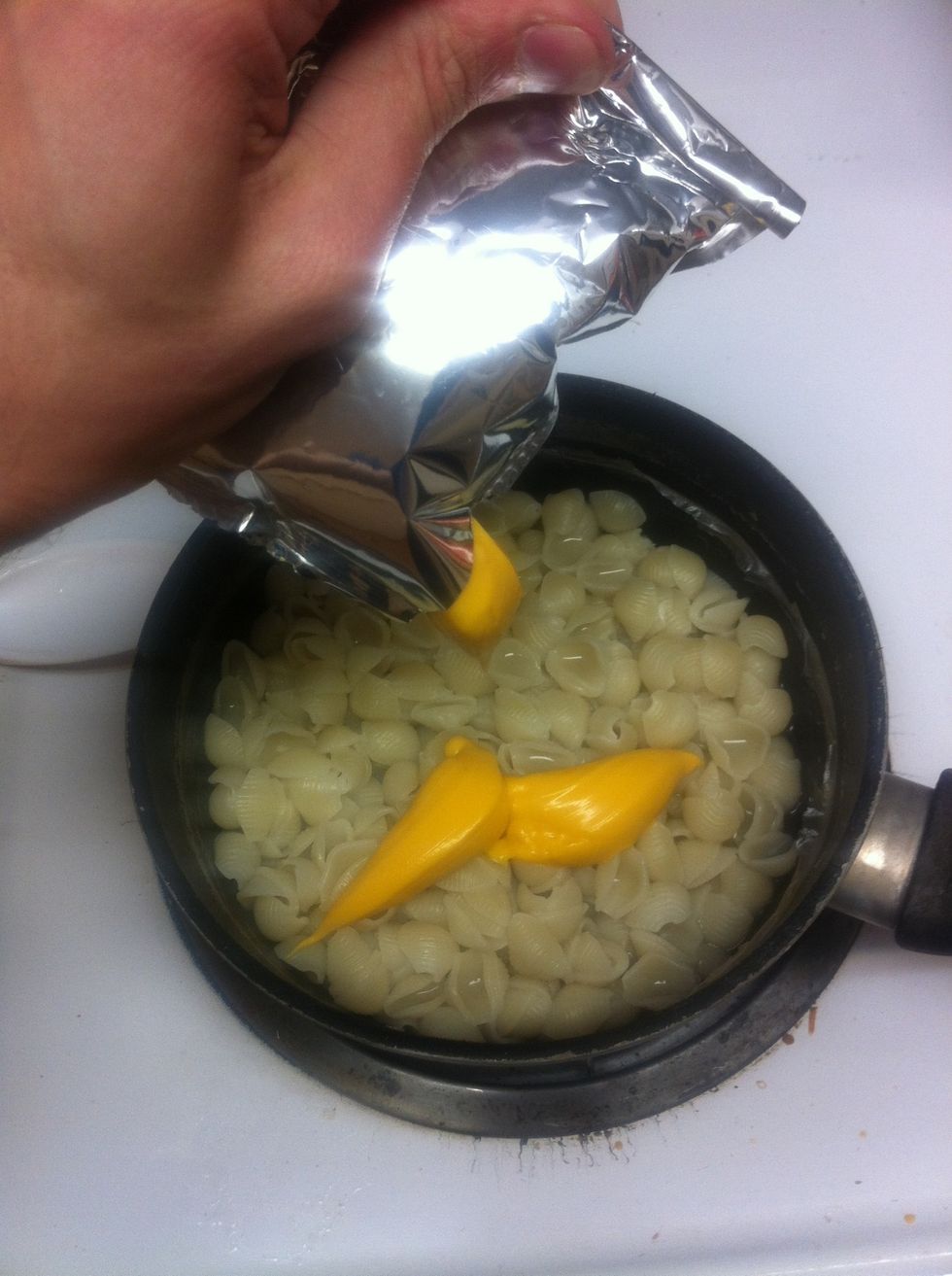 Squeeze in cheese hole hotdogs are cooking.