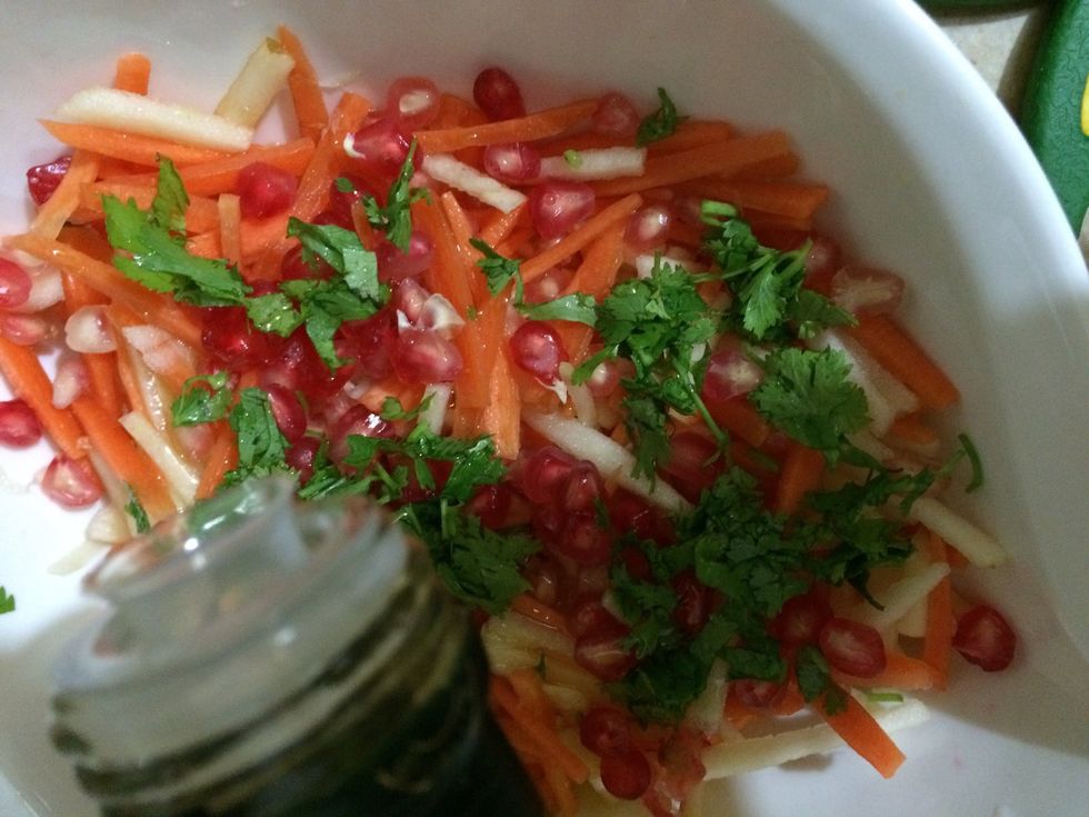 Squeeze orange juice into the salad, and pomegranate seeds. Drizzle olive oil