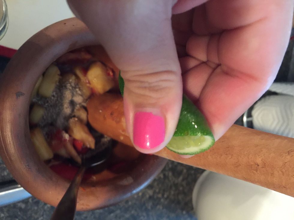 Squeeze some lime. Keep stirring and smashing a little more and taste the pineapple to see if it tastes good. I added a little more fish sauce and squeezed a little more lime.