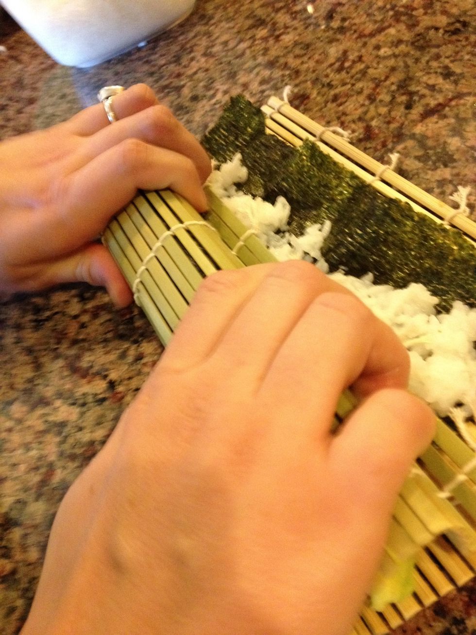 Squeeze the bamboo mat to tightly pack the roll's shape.