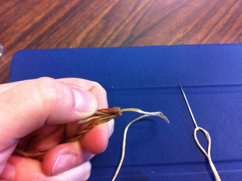 Squeeze the end of the thread between the ends of the floral wire to anchor the end and hide it.