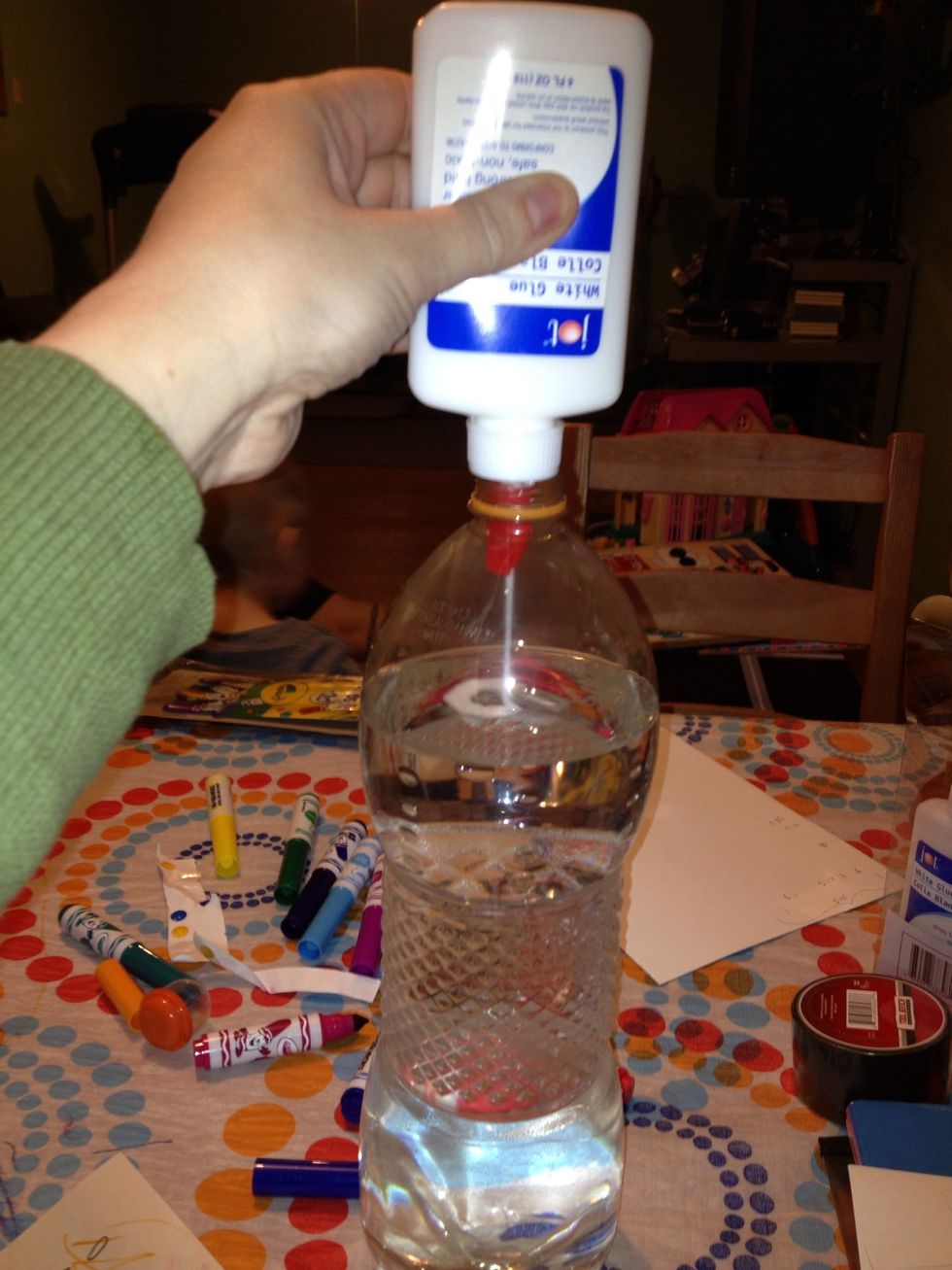 Squeeze the glue into the water, cap the bottle, and shake to mix.