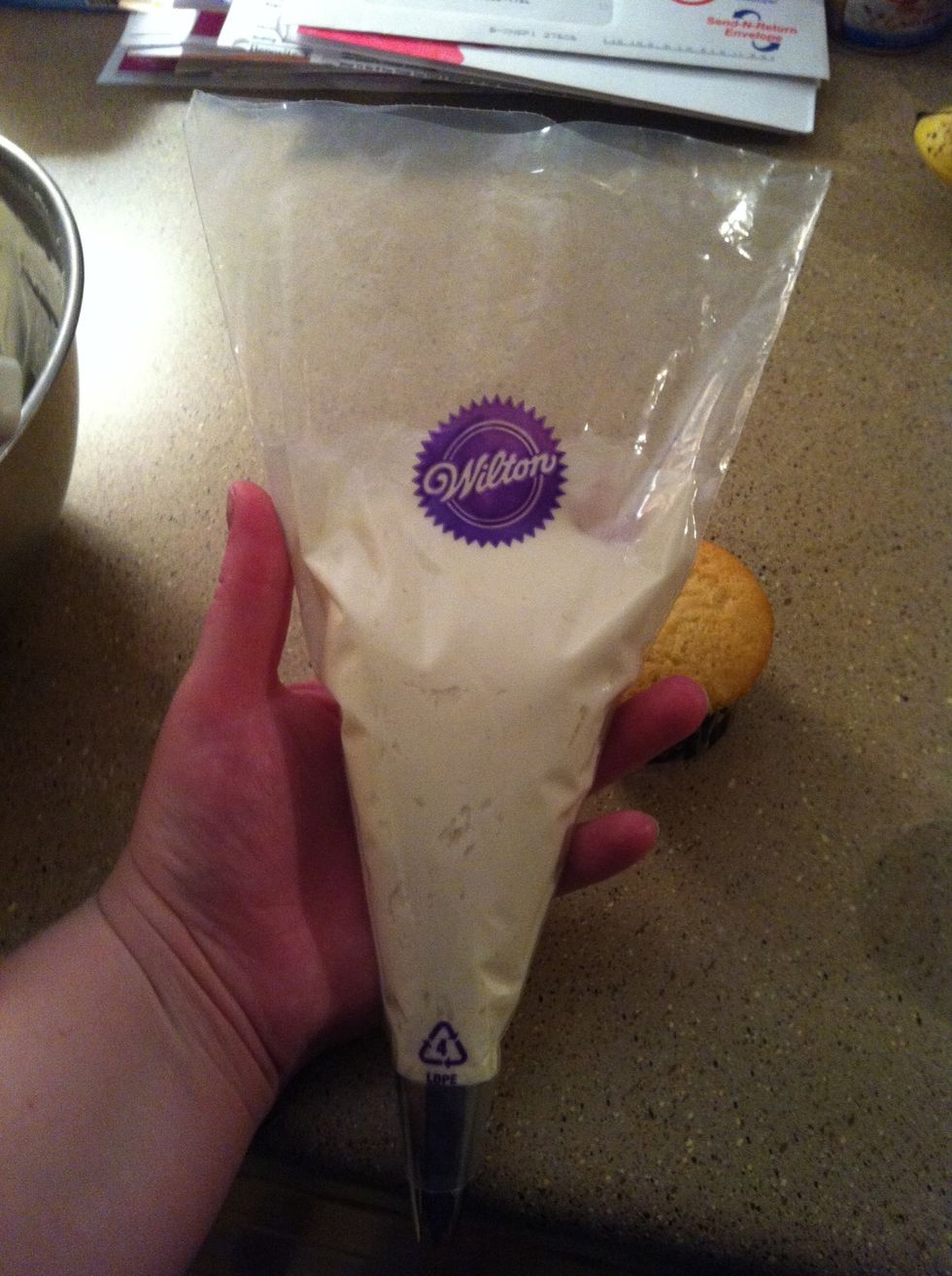 Squeeze the icing down to remove air bubbles. Just like when you're trying to get the last bit of toothpaste! But take care to not allow the icing to come out of the tip.