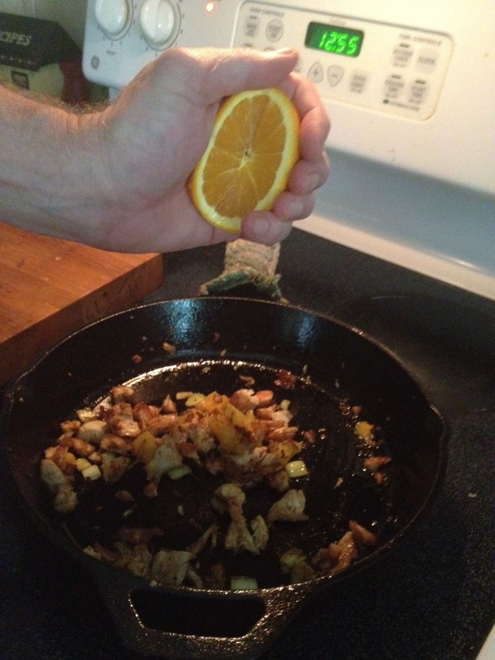 Squeeze the juice from the other orange slice into the pan. SQUEEZE it hard!.  I told you this was the sloppy part. (Have the trash can handy do you can toss the squished orange into it). Stir it.