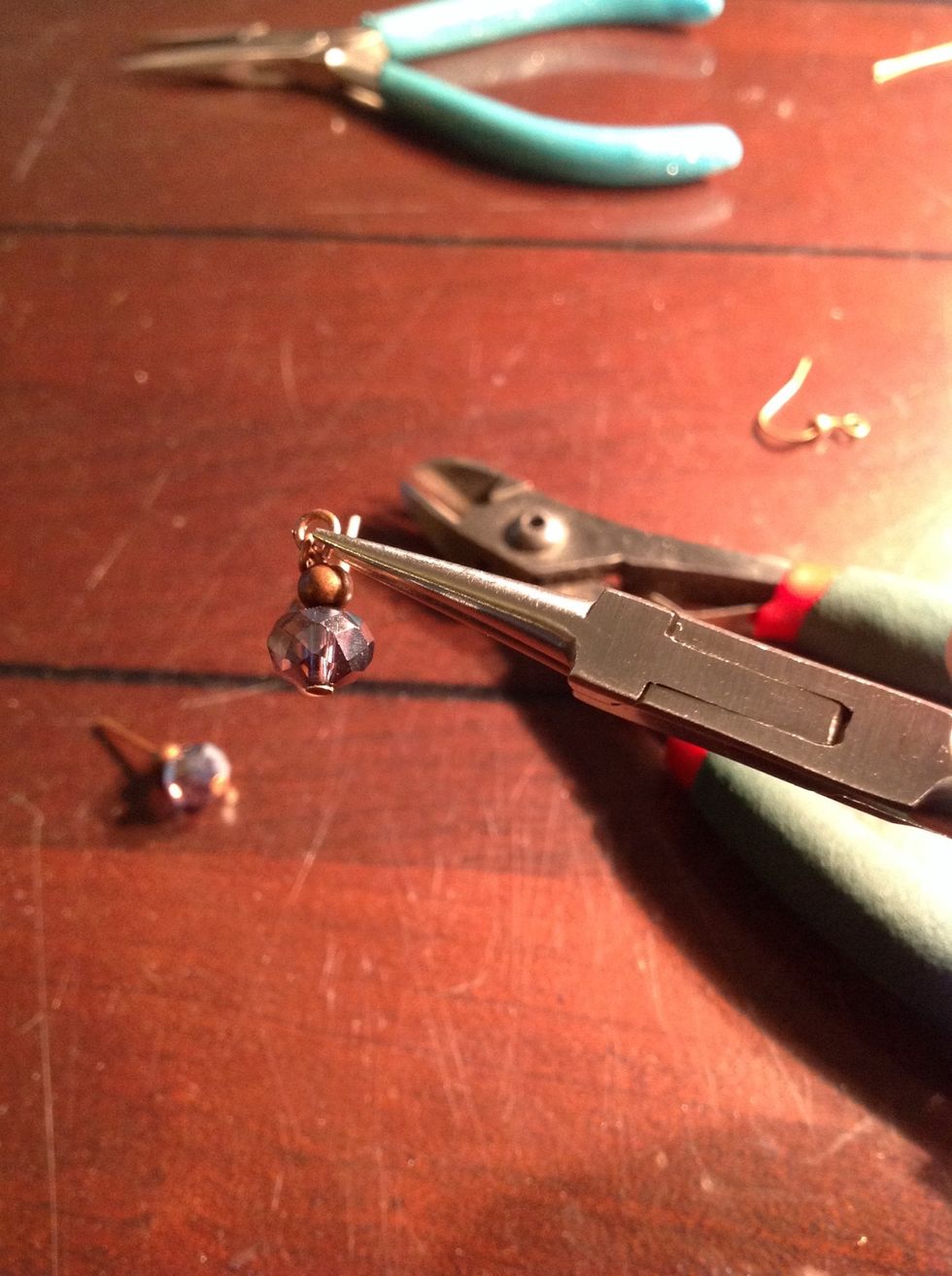 Squeeze the loop closed to secure the ear wire inside the loop