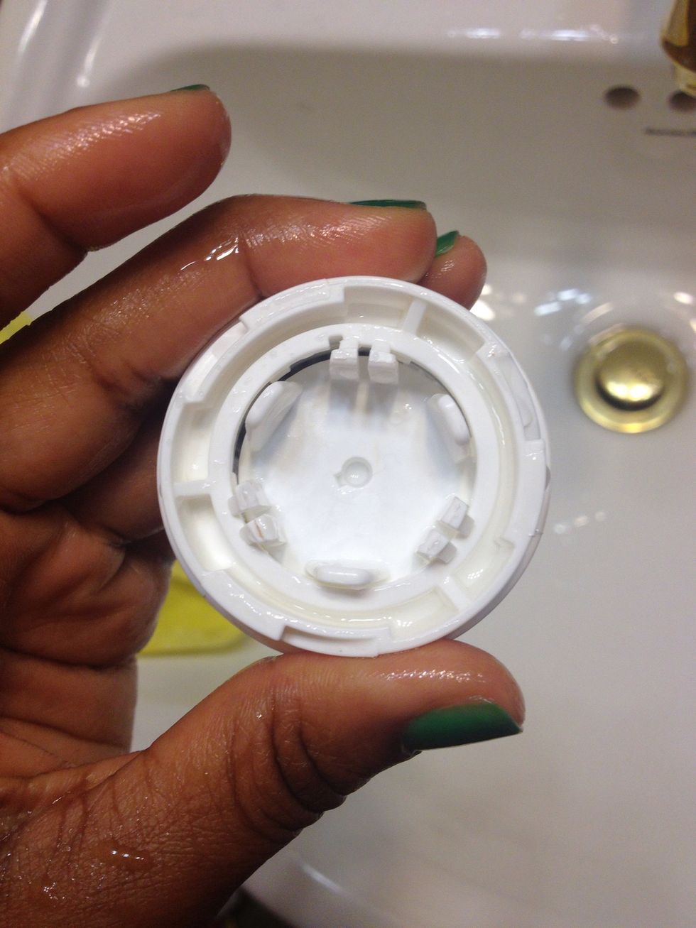 Squeeze the prongs shown above to remove center part of the brush head.