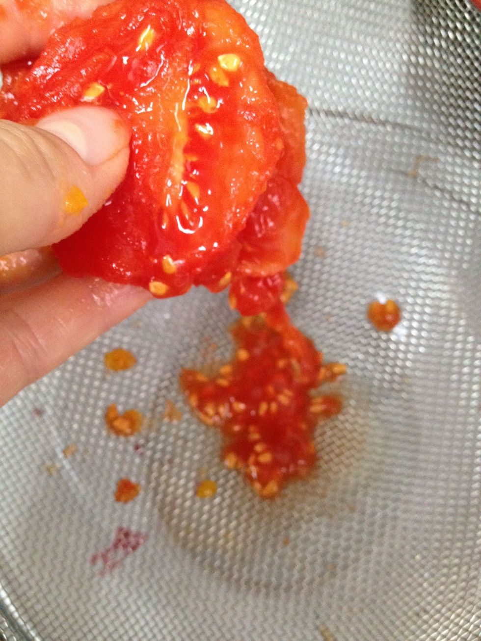 Squeeze the seeds out over a strainer into a bowl. Seeds can cause sauces to taste bitter so you want to rid as many of them as possible. This is a great job for the kiddos\u2014it's okay to be messy!