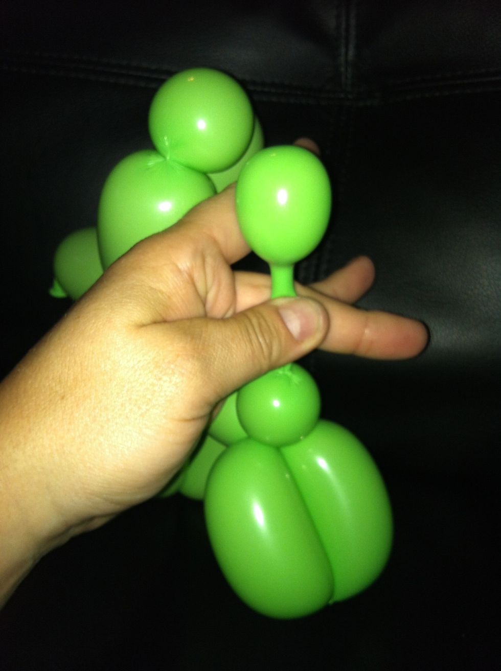 Squeeze top bubble into uninflated portion of the balloon