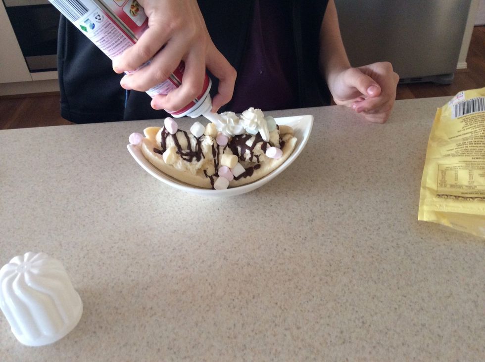 Squirt the whipped cream in nice decorative swirls along the top of the banana and ice cream. \ud83d\ude03