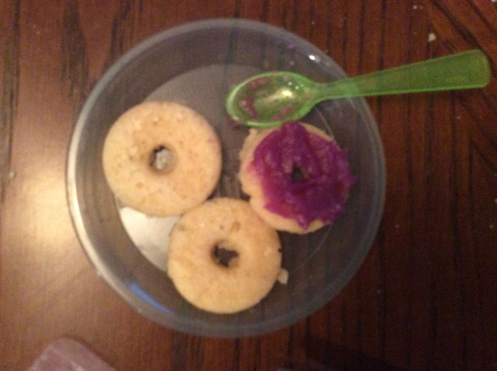 Squirt your icing on to your donuts. I just used my spoon and flattened them out a little bit because they were really messy looking.\ud83c\udf47