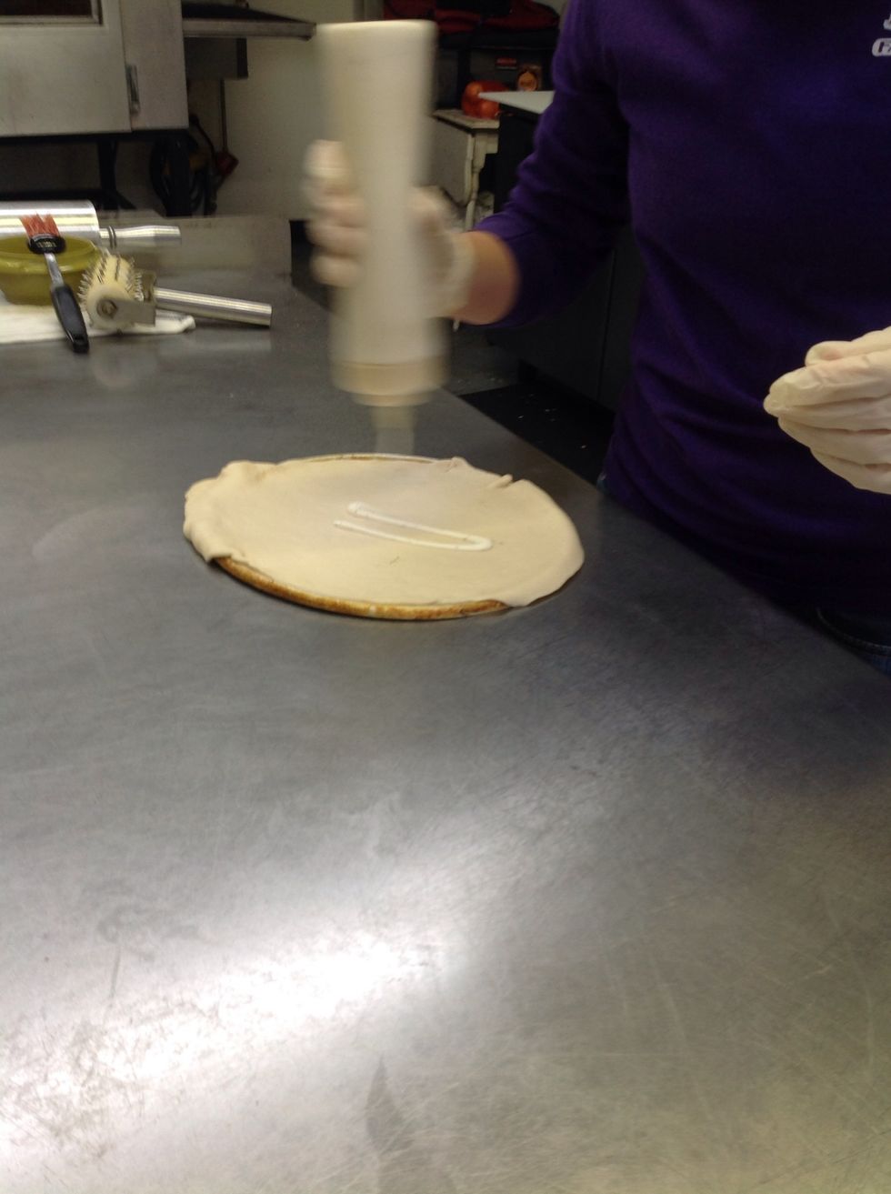 Squirting ranch over the dough