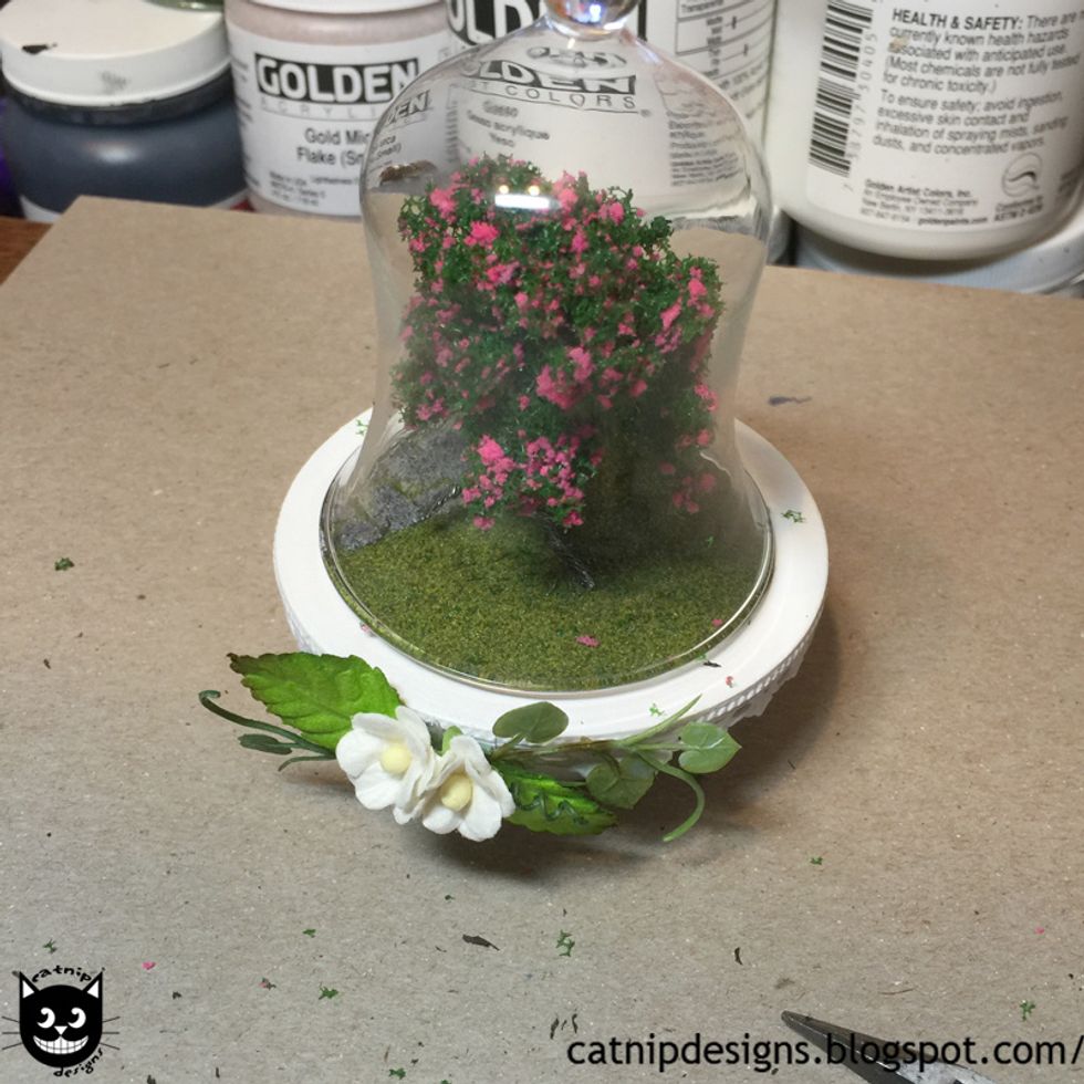 Squish and shape the top of the Tiny Tree with Pink Blossoms until it fits under the Large Glass Bell Dome.