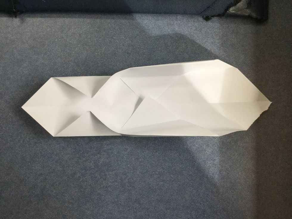 Squish on sides corners in to touch the centre and fold up the back as shown.