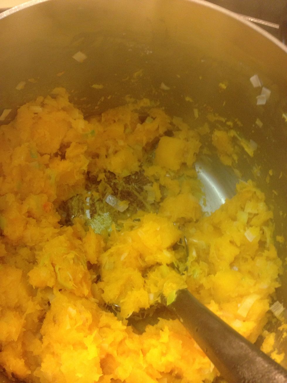 Squish the squash and scrape up the brown bits on the bottom of the pot.