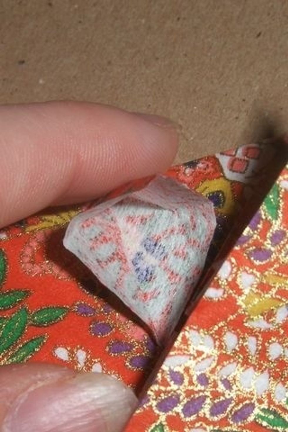 Squish the triangle you just folded out into a square.