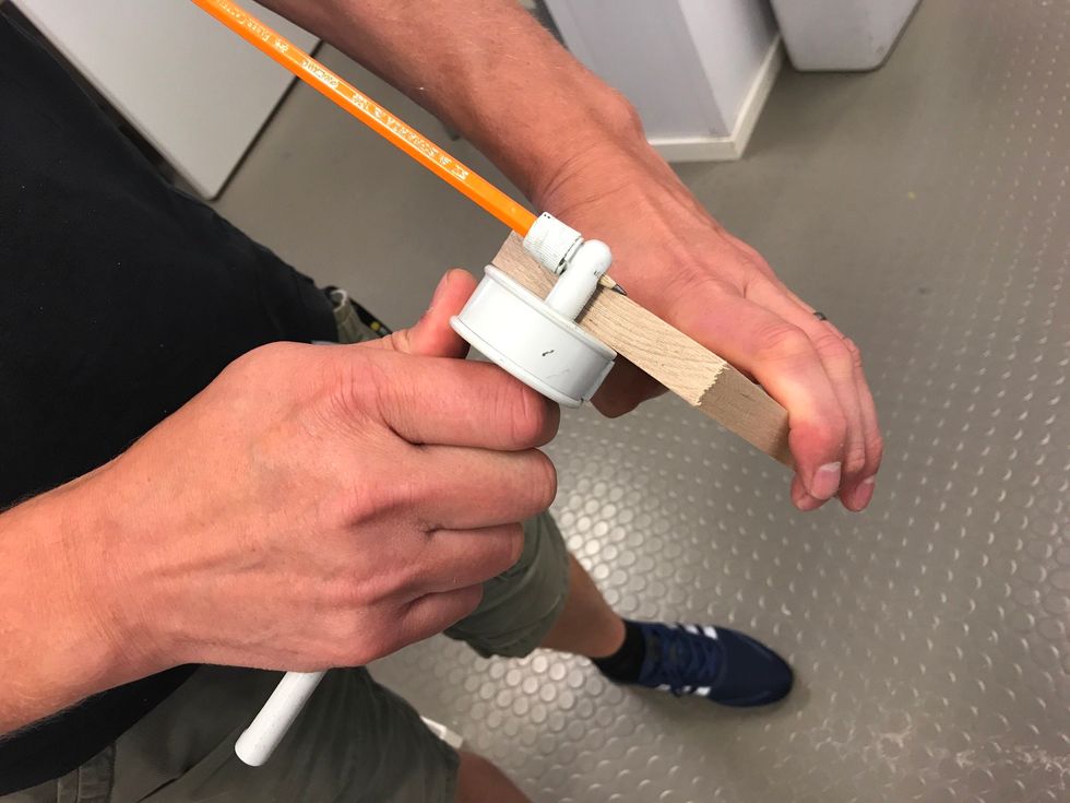 St\u00e4ll in ett strykm\u00e5tt p\u00e5 detta vis s\u00e5 att pennspetsen precis trillar ner bredvid br\u00e4dans kant.