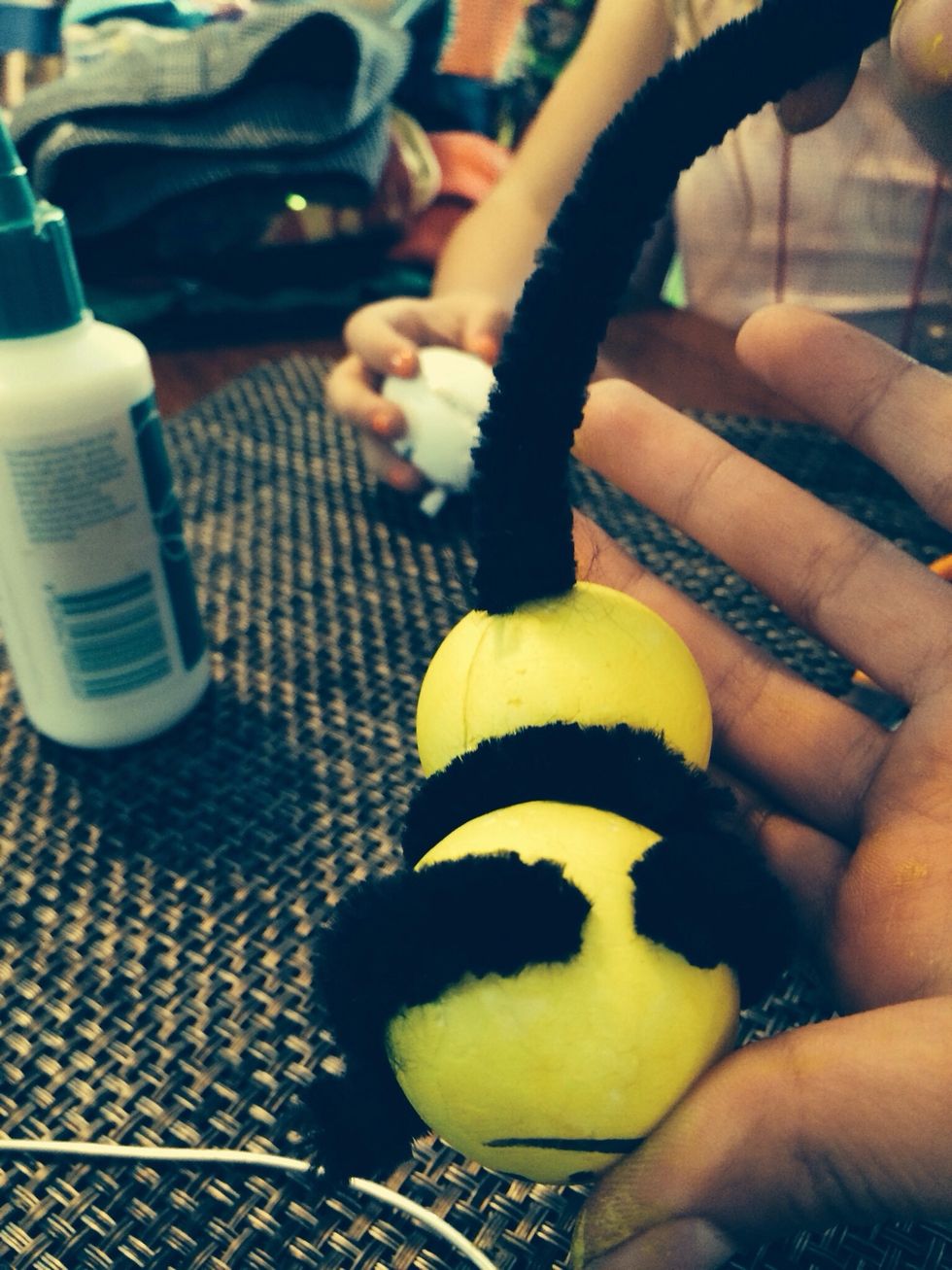 Stab a pipe cleaner into the middle of the second ball.