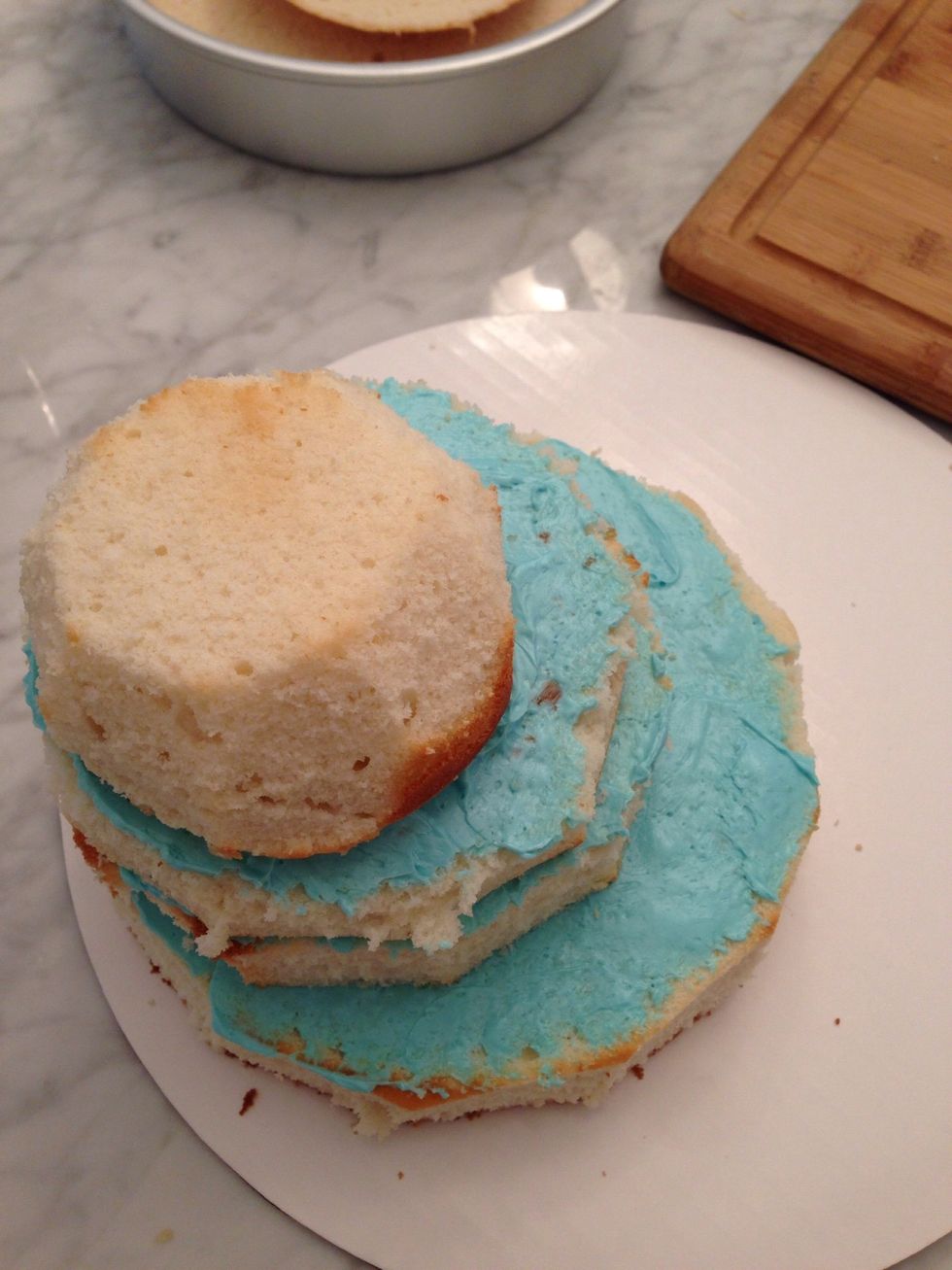 Stack 3 cakes off to one side. 8 inch cake, 6 ' cake, and last one just made from in a soup bolw