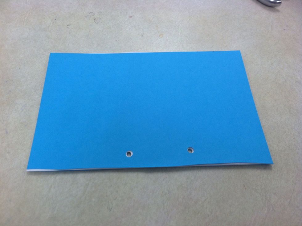 Stack and tap. Cover-pages- back cover. Make sure holes line up. Repeat until they do.