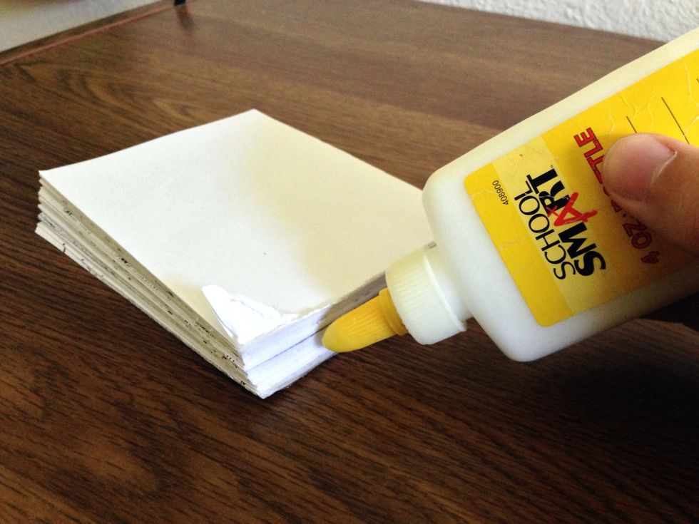 Stack each square sheet on top of each other and glue across the top. Use bottle glue.