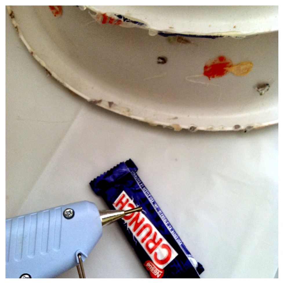 Stack the bowls and hot glue together. Once you have a design in mind, start at the bottom gluing the mini candy bars leaving no space for the bowls to be seen.