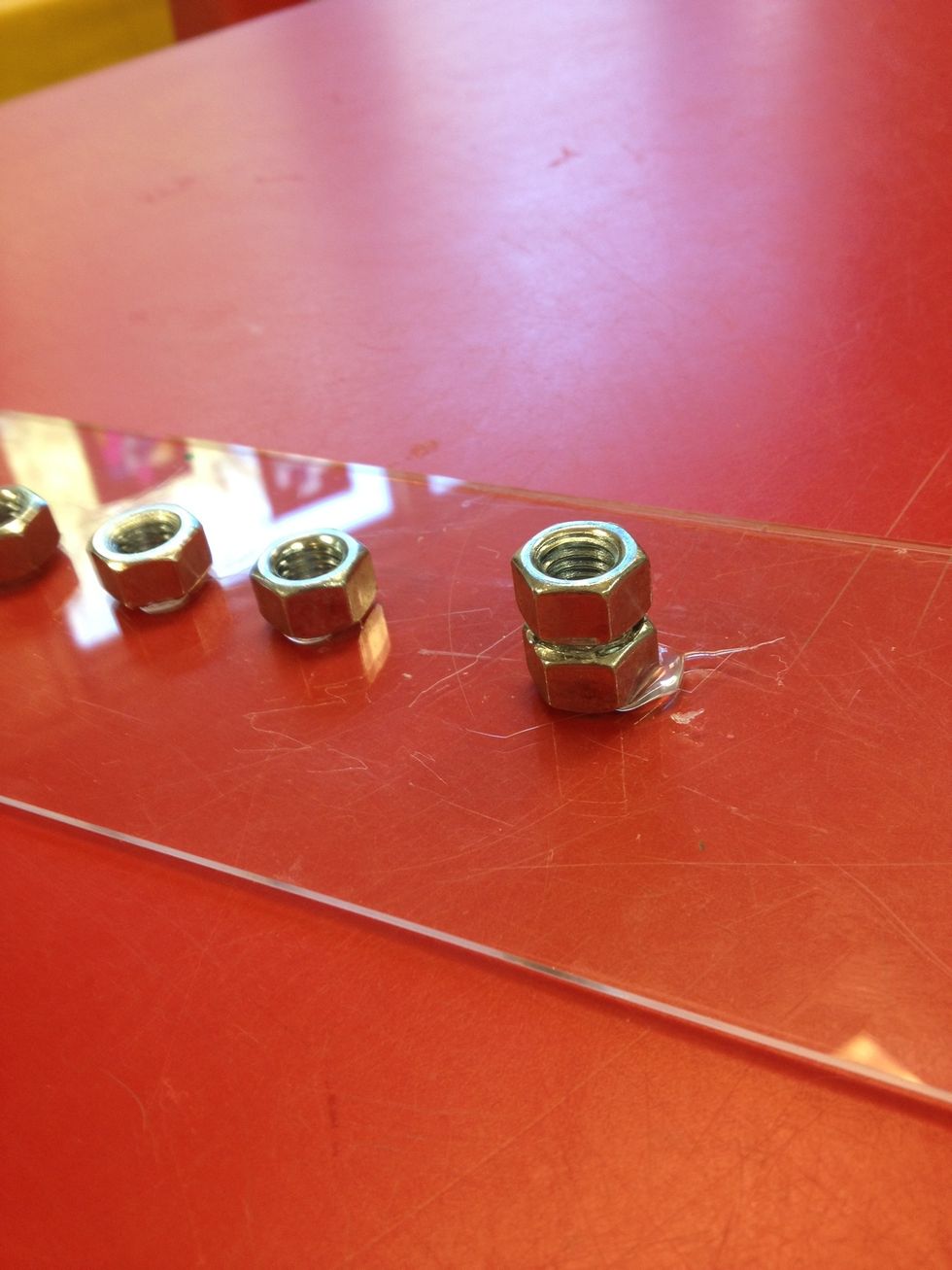 Stack two hex nuts at one end for the Shamash candle which is always taller than the others.