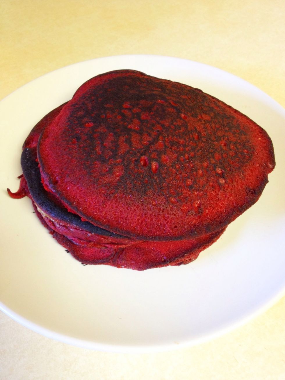 Stack your finished red velvet pancakes on a plate & sprinkle powdered sugar on top. Serve with syrup & your choice of breakfast drink (ie: coffee, mimosa, cranberry juice...etc)
