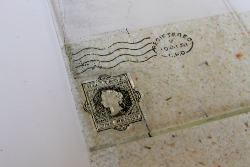 Stamp a few postage stamps with the Postale clear stamps on the "Adventure" paper.