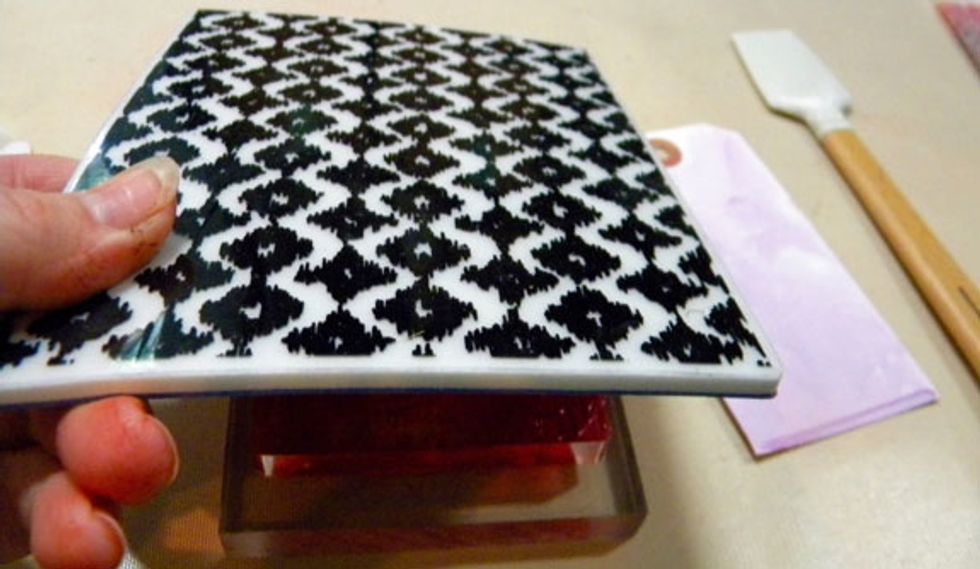 Stamp a large background stamp onto the Gelli plate. Make sure to clean the paint off of the stamp before it dries.