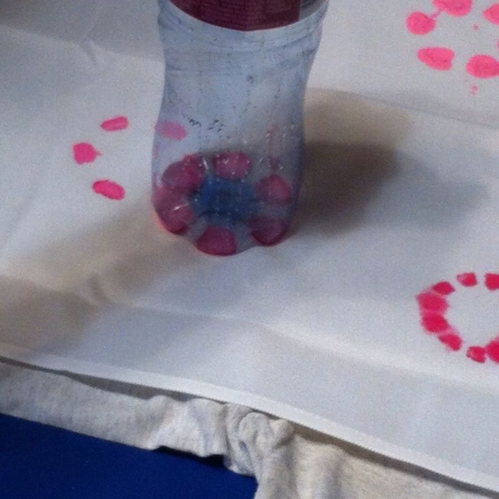 Stamp the fabric. FYI: if you have a lot of paint on the bottom of the bottle, it WILL bleed. However, these are kid created for a kid room, I liked to loose look of the prints.