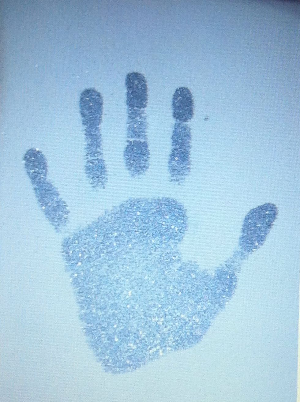 Stamp the hand down on good quality watercolor paper and sprinkle the print with embossing powder. Heat set.