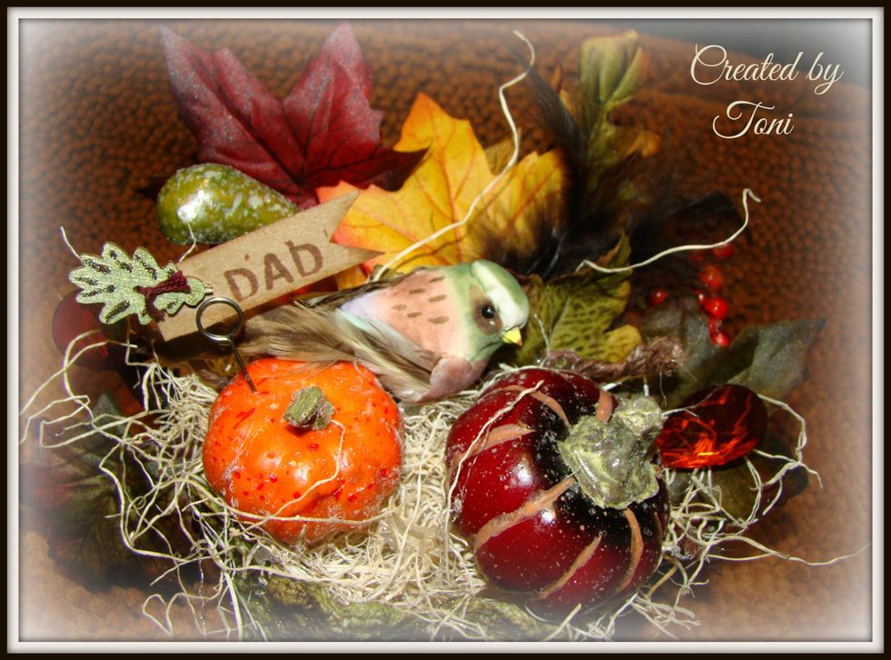 Stamp the individuals name on Kraft paper. Cut in a shape of a banner and distress the edges with Vintage Photo Distress Ink. Using Ideology Memo Pins secure your name tags.