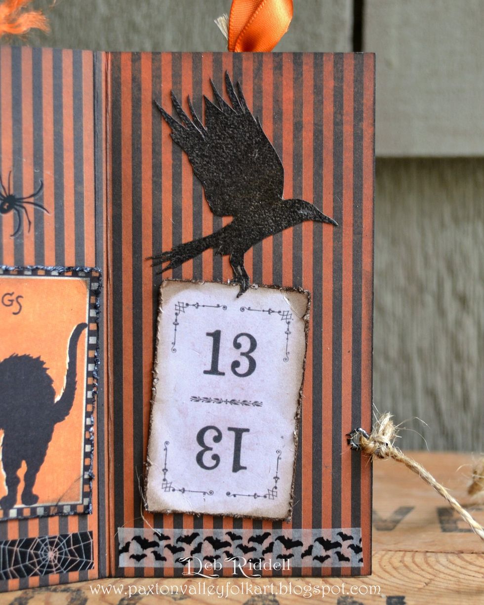 Stamp the raven from Regions Beyond onto cardstock, clear emboss and fussy cut. Tatter the edges of the '13' playing card from the Frightful Ephemera pack and adhere. Add another strip of washi tape