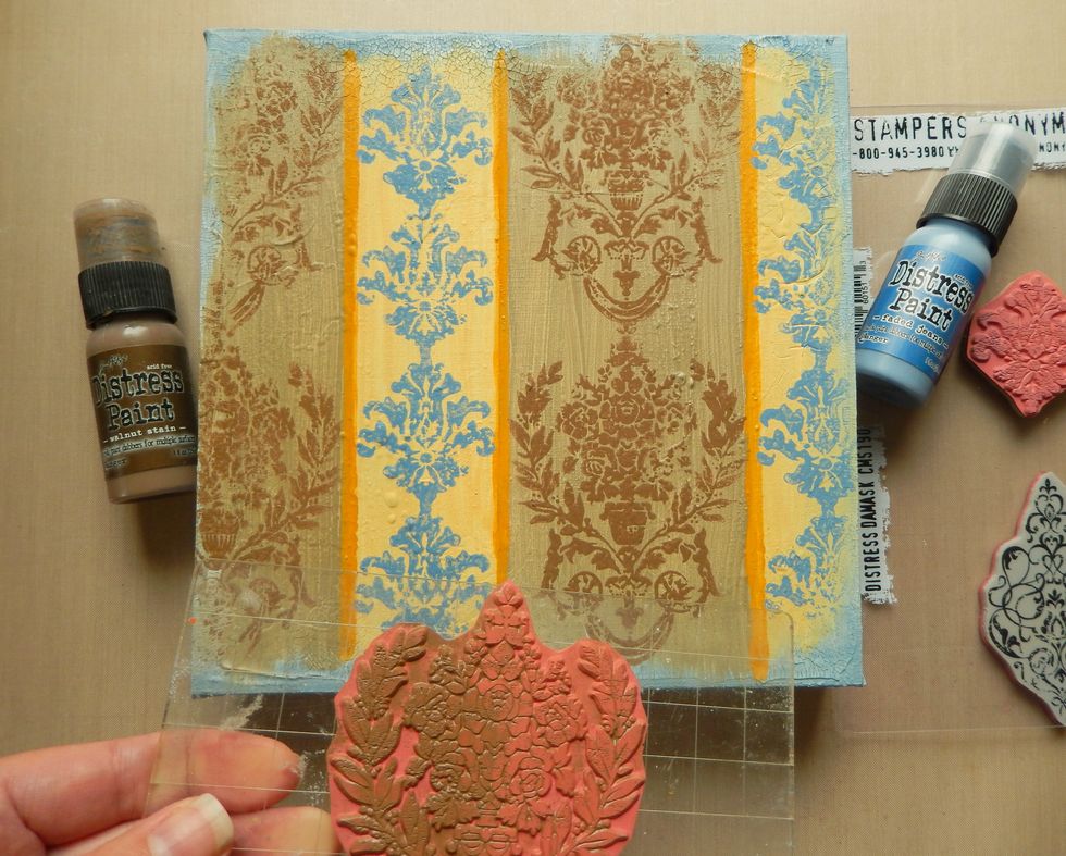 Stamp your chosen Distressed Damask designs using Walnut Stain Distress Paint over the brown lines and Faded Jeans Distress Paint over the yellow lines. It looks good if your stamping is uneven here.