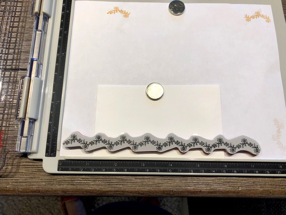 Stamp your image along the bottom edge of your envelope. Use a stamping platform to stamp your image multiple times. This makes sure your image is aligned correctly every time.