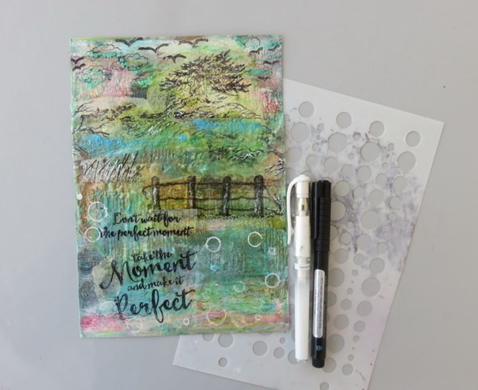 Stamps the sentiment in the same way as images and glue them as shown. Draw a few birds with black pen and make some white pen highlights.Draw some white pen circles with AA Bubbles stencil.