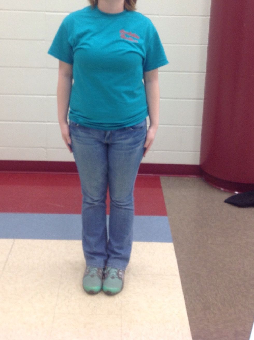 Stand facing the front with feet together and hands by your side.