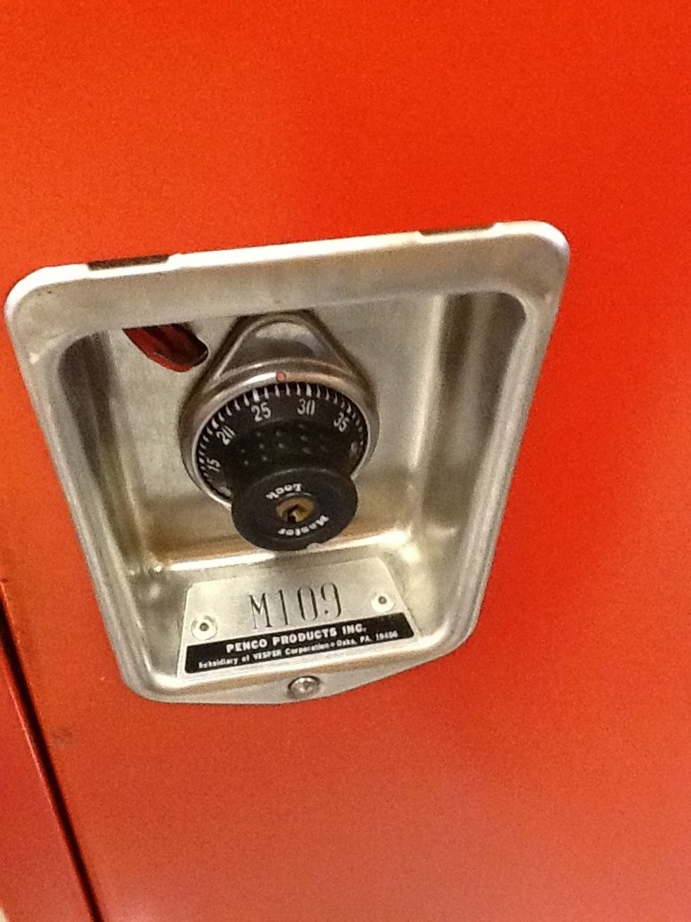 Stand in front of your locker. Be sure you are at your locker and not your neighbor's locker.
