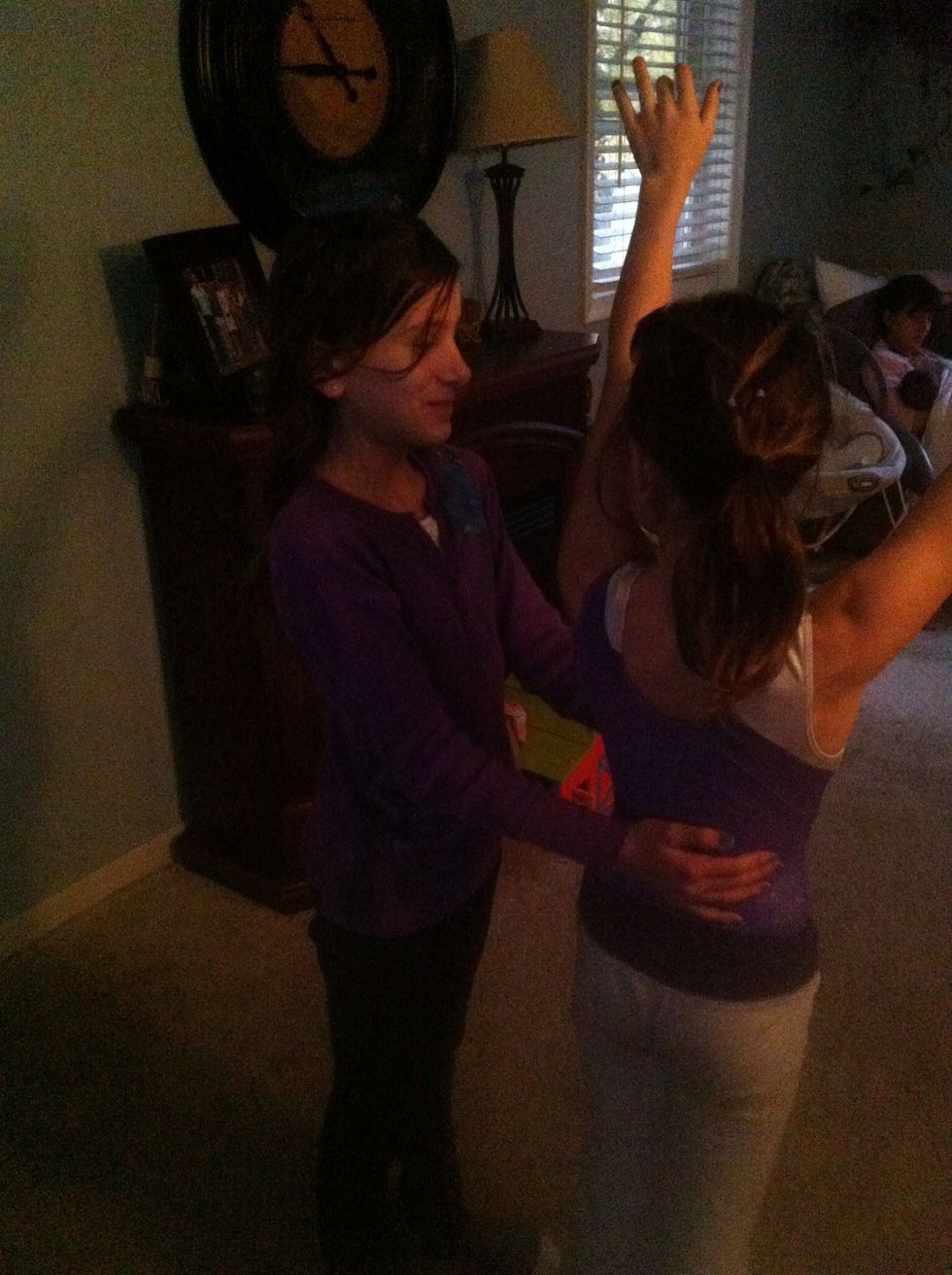 Stand up straight. Have the 'spotter' stand beside you with one hand on your stomach and the other on your lower back.