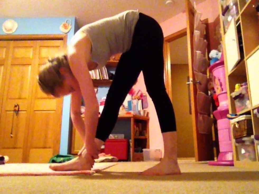 Standing calf stretch: Stand with one foot in front of you then bend down and grab your ankle with your hands.