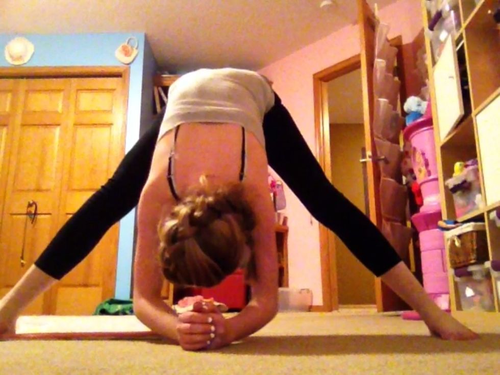 Standing straddle: Start standing with your legs far apart. Bend down and touch the ground with your hands or elbows.