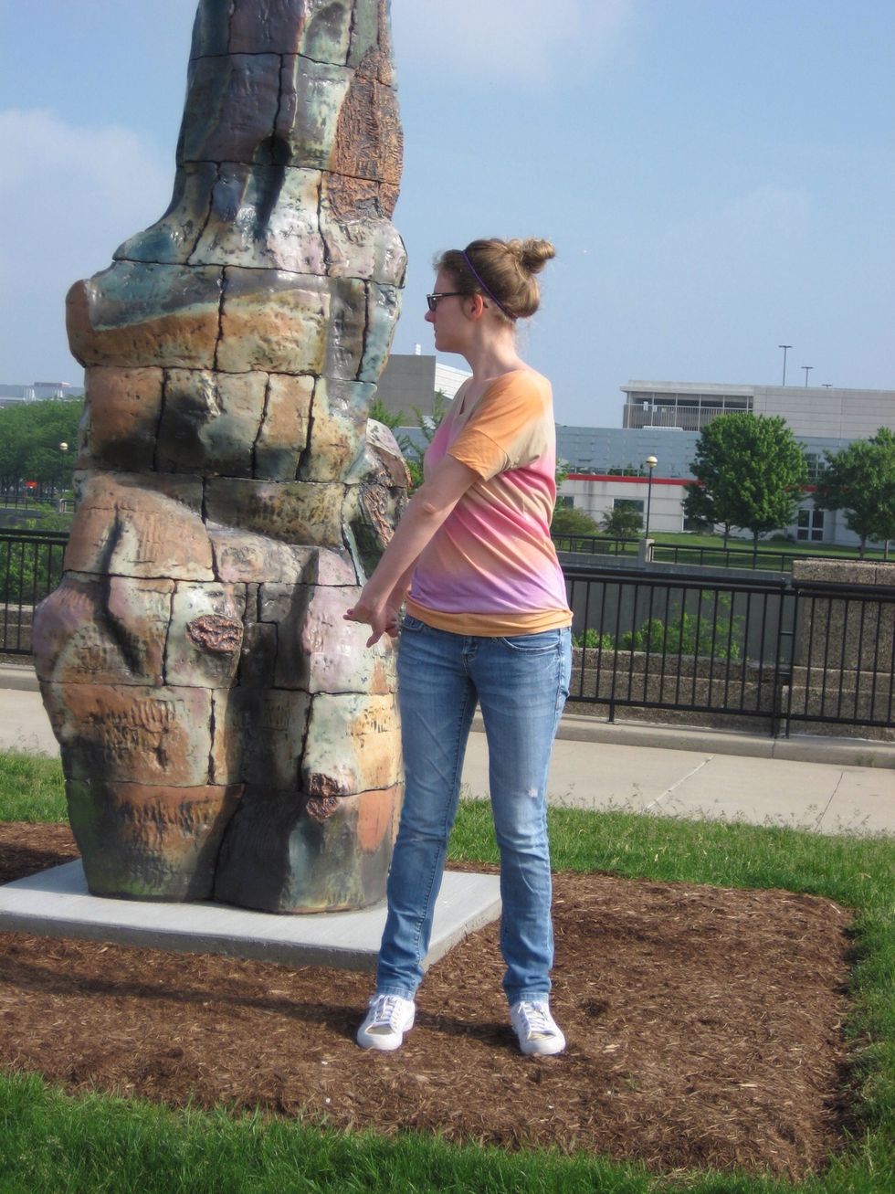 Standing twist \u2013 w/ fingers interlaced press palms down with straight arms, turn shoulders to right, then left