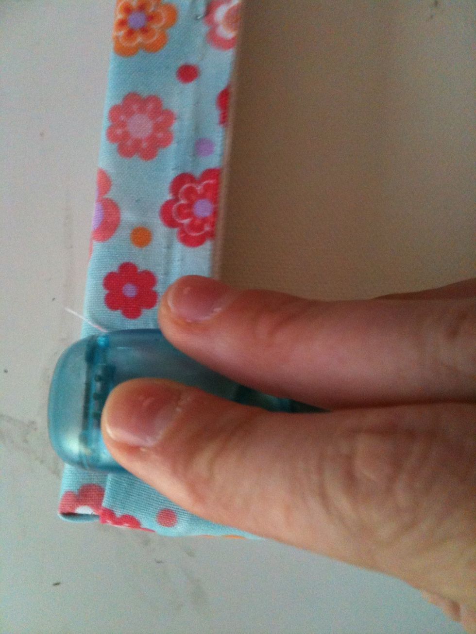 Staple the material onto the canvas